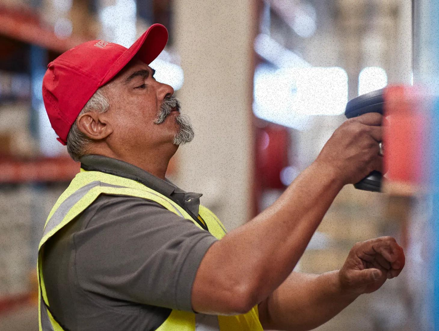 A man in his fifties working at a national hardware and lumber store. He’s fitting in easier diabetes management in his busy life with a virtual chronic care program.