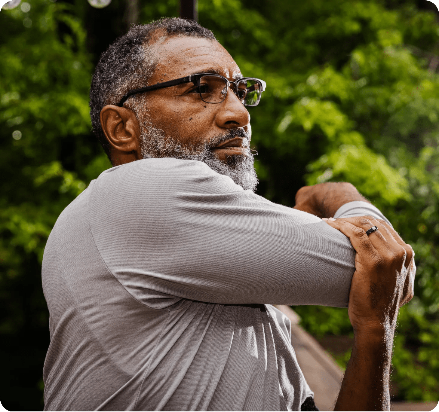  A black man in his late fifties stretching before getting his steps in as discussed with his diabetes care program health coach.