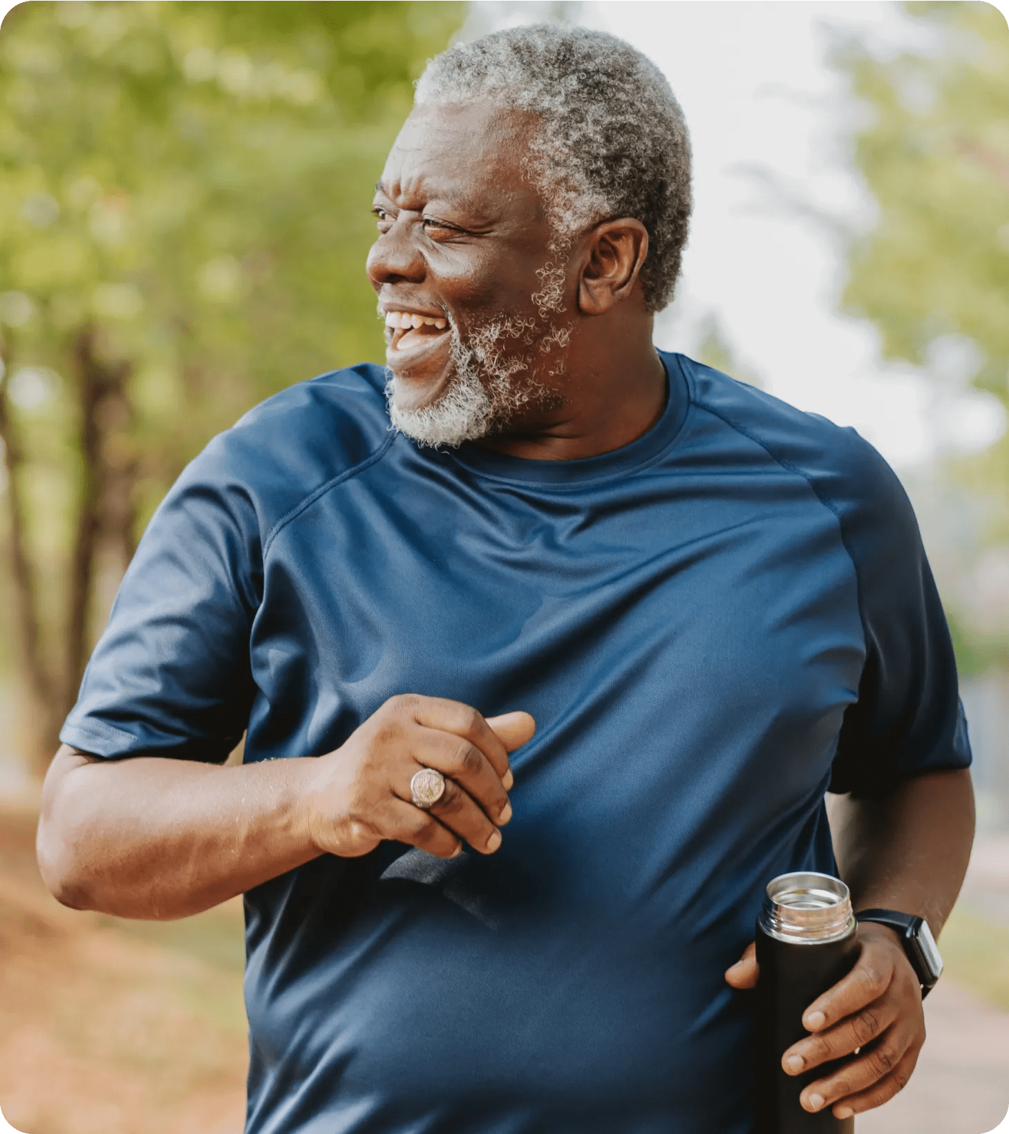 A black man in his early fifties, getting his steps in at the park.