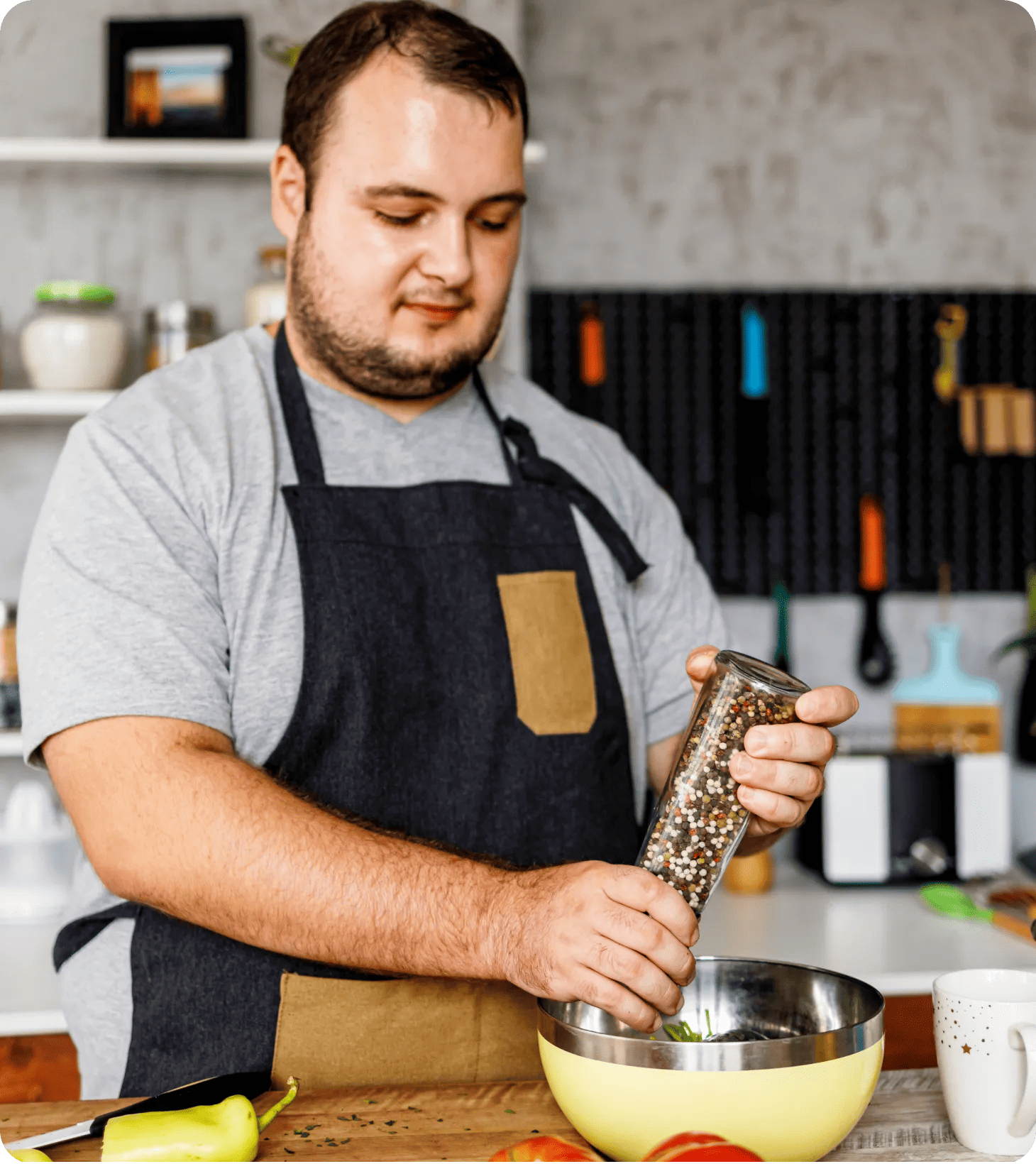A middle-aged man in their kitchen making a healthy salad recipe.