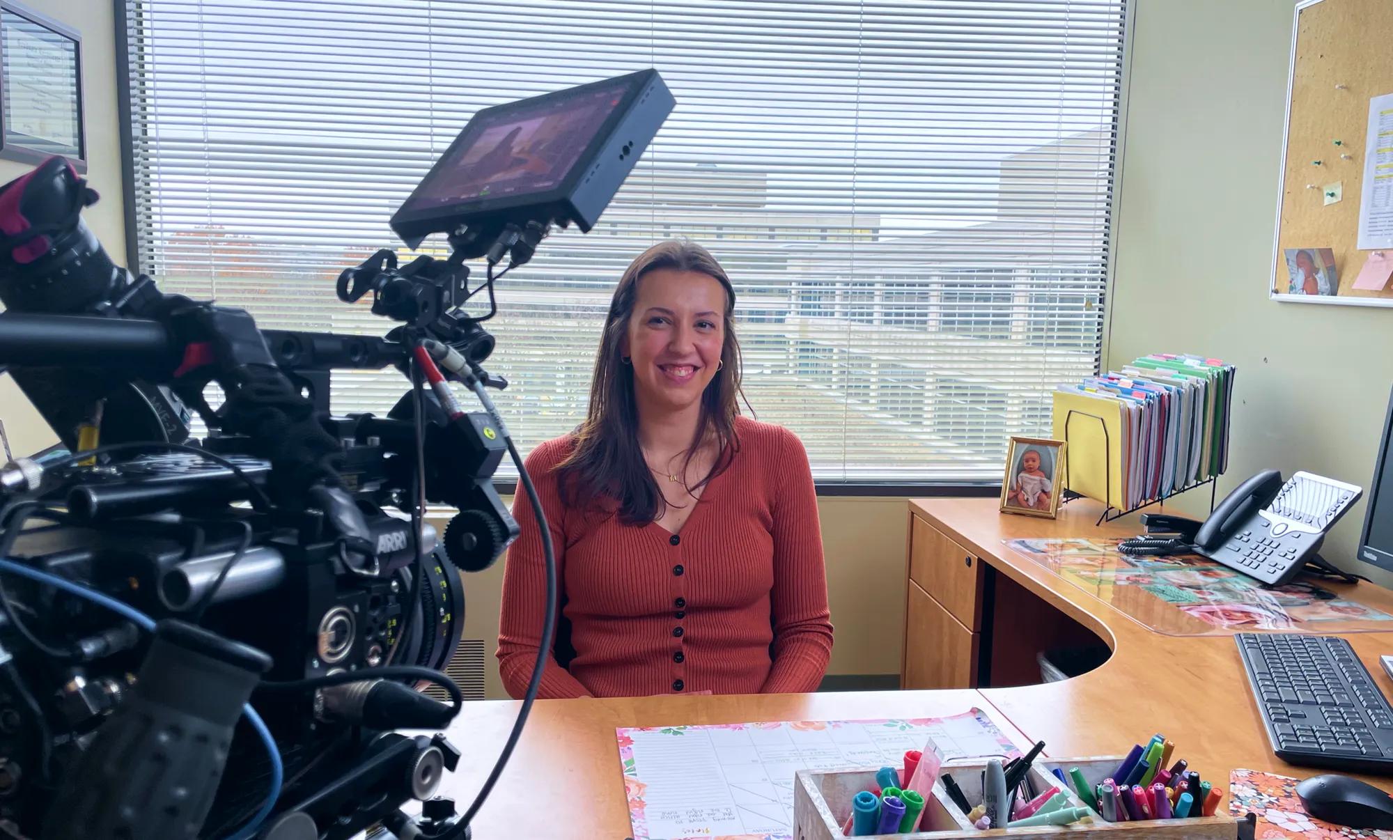 A research manager at the American Oncology Network, The Center for Cancer and Blood Disorders smiling during filming of Verily’s N of 1 docuseries.