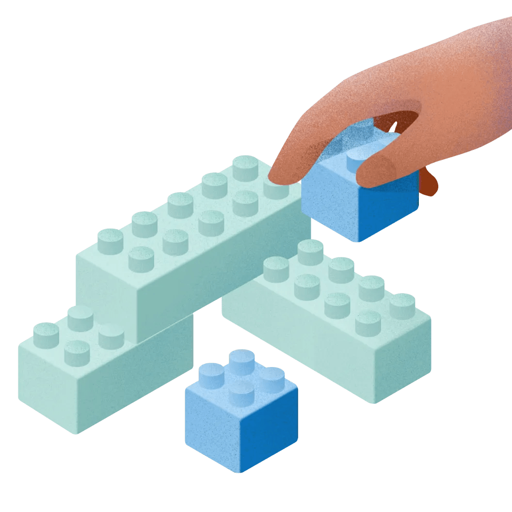 Illustration shows a hand building a structure with interlocking bricks