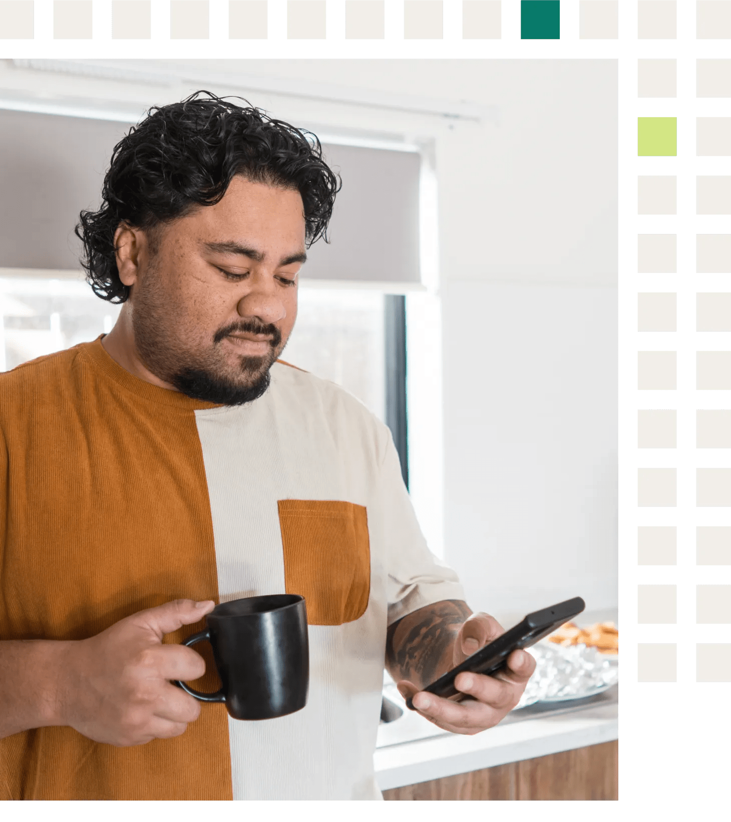 A person in his forties with prediabetes and hypertension looking at his virtual chronic care program app for healthy breakfast choices while having coffee in his kitchen.