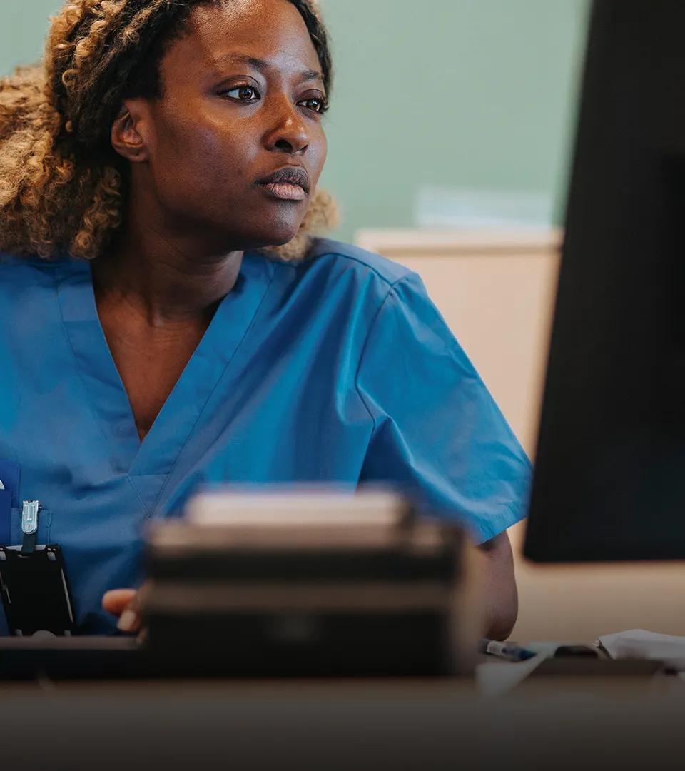 Clinical researcher at a study site, using a clinical trial management system. 
