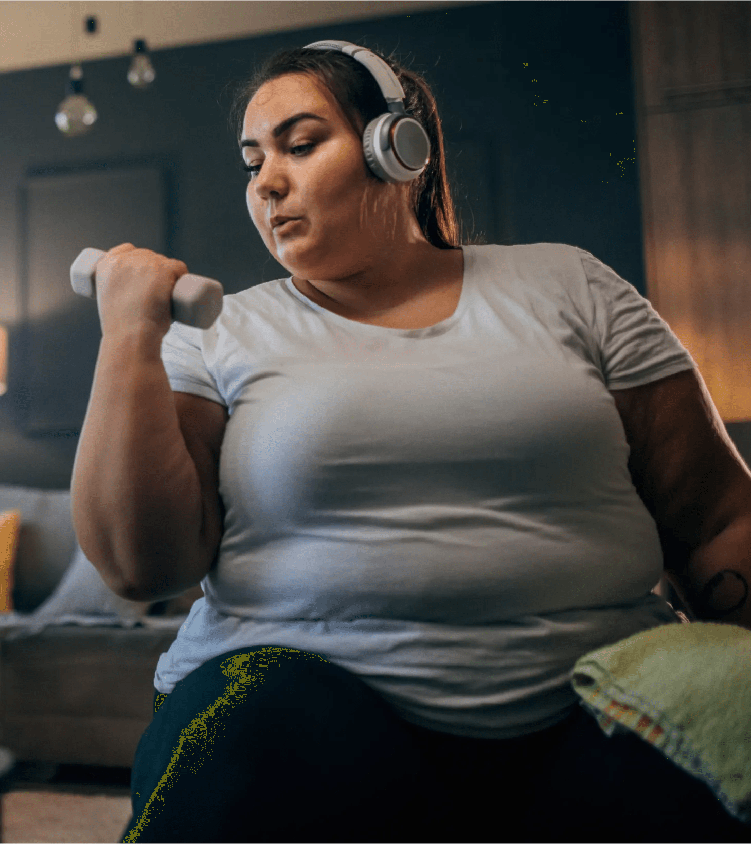 A woman in her early thirties and listening to music as she fits in physical activity to her daily routine as part of her virtual care program for managing obesity.