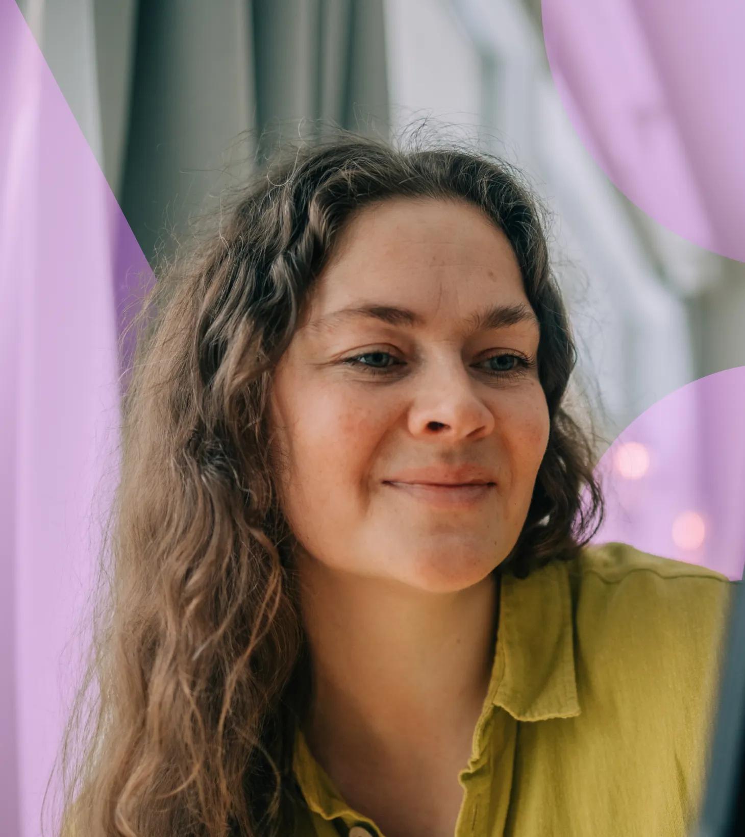 Woman smiling holding a phone