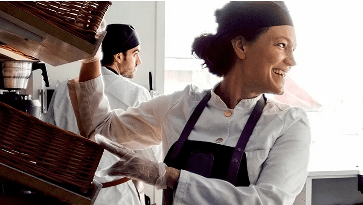 A woman in her forties smiling while at work. She’s happier because she’s fitting easier diabetes management in her busy life with a virtual program