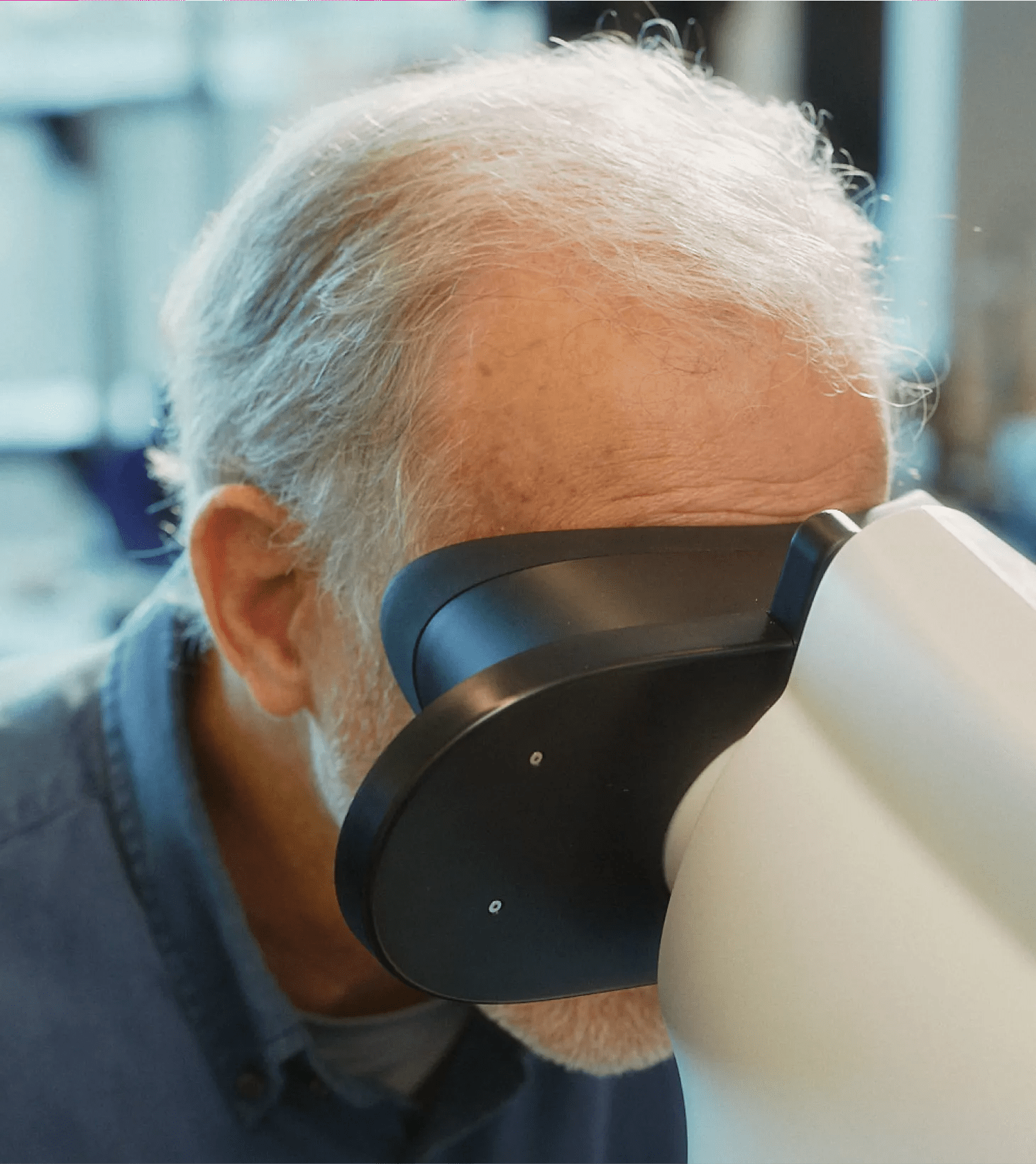 Patient placing their head onto the Verily Retinal Camera for screening