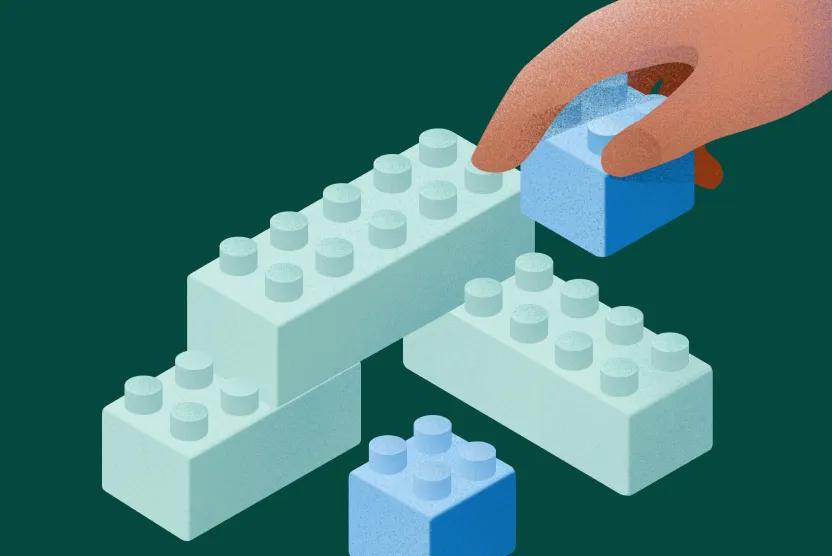 Illustration shows a hand building a structure with interlocking blue bricks on a dark green background