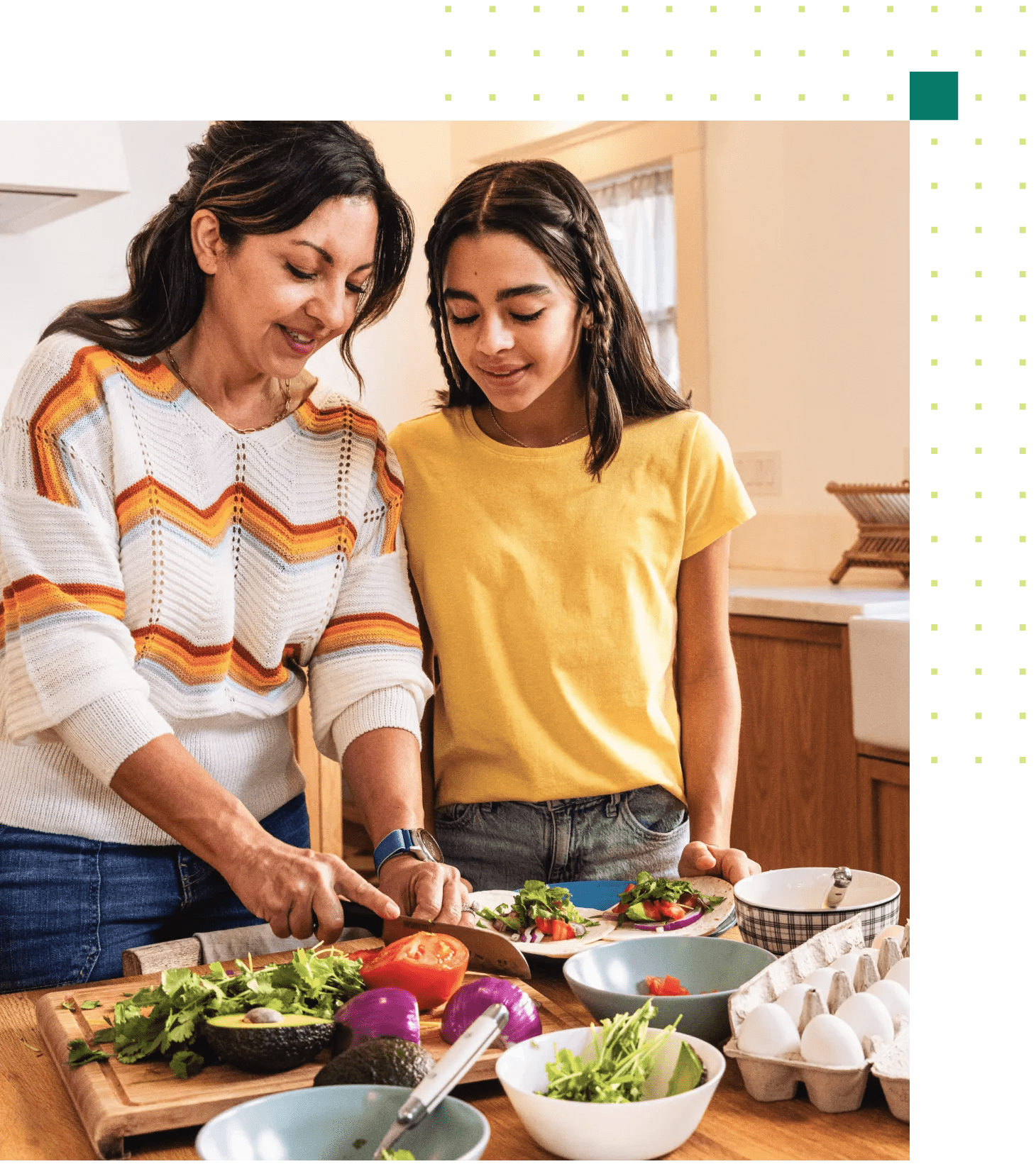 A Hispanic-descent, middle-aged woman with her pre-teen daughter in their kitchen making a healthy dinner recipe.