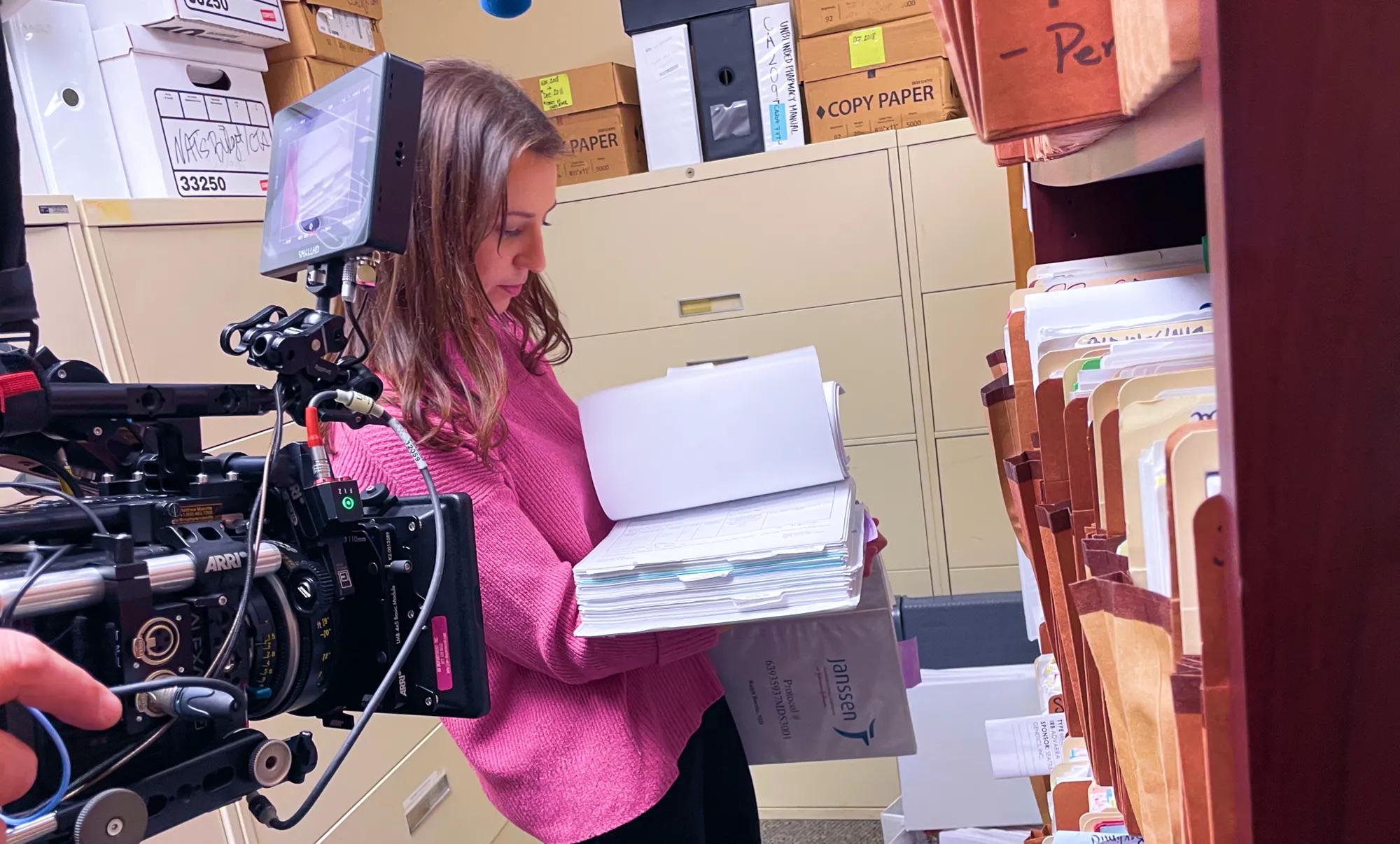 A research manager, sorting through vast amounts of clinical trial protocol documents and files at the American Oncology Network, The Center for Cancer and Blood Disorders.