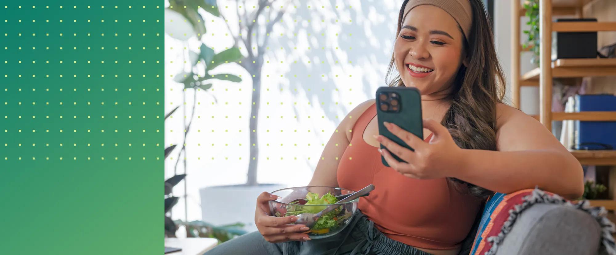 Woman on her cell phone who’s interacting with a virtual weight loss program.